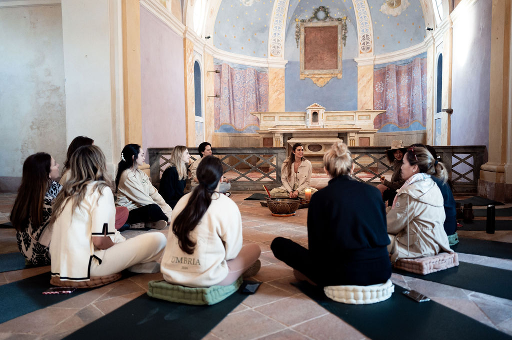 Shayna leading circle in frescoed chapel